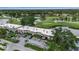 Aerial view of property showcasing lush golf course and waterways behind buildings at 7301 W. Country Club N Dr # 108, Sarasota, FL 34243