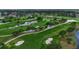 Enjoy an aerial view of the lush green golf course, beautiful lakes, and manicured landscaping surrounding the property at 7301 W. Country Club N Dr # 108, Sarasota, FL 34243