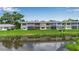 Back exterior of a condo overlooking a pond, with a screened lanai circled in red at 7301 W. Country Club N Dr # 108, Sarasota, FL 34243