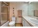 Charming bathroom with whimsical seashell wallpaper and practical layout featuring toilet, sink, and shower at 7301 W. Country Club N Dr # 108, Sarasota, FL 34243