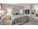 Inviting bedroom showcasing floral bedding, soft carpet, and decorative wall art for a comfortable ambiance at 7301 W. Country Club N Dr # 108, Sarasota, FL 34243
