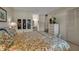 Comfortable bedroom featuring floral bedding, a TV, and convenient access to an ensuite vanity area at 7301 W. Country Club N Dr # 108, Sarasota, FL 34243
