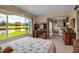 Bright bedroom featuring a desk area, large window overlooking scenic view, and comfortable bed at 7301 W. Country Club N Dr # 108, Sarasota, FL 34243