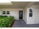 Front door and windows surrounded by lush, verdant bushes creates an inviting entrance to this lovely home at 7301 W. Country Club N Dr # 108, Sarasota, FL 34243