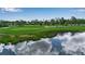 Scenic aerial view of pond in golf course reflecting clouds on a sunny day at 7301 W. Country Club N Dr # 108, Sarasota, FL 34243