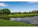 Picturesque view of the golf course with lush green fairways and a tranquil pond at 7301 W. Country Club N Dr # 108, Sarasota, FL 34243