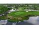 Aerial view of the golf course featuring pond, trees, and sand trap at 7301 W. Country Club N Dr # 108, Sarasota, FL 34243