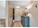 Inviting hallway with tiled flooring, patterned wallpaper, a turquoise chest, and an open door at 7301 W. Country Club N Dr # 108, Sarasota, FL 34243