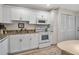 Efficient kitchen features white cabinets, granite counters, and modern appliances at 7301 W. Country Club N Dr # 108, Sarasota, FL 34243