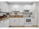 Efficient kitchen features white cabinets, granite counters, and modern appliances at 7301 W. Country Club N Dr # 108, Sarasota, FL 34243