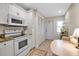 Bright eat-in kitchen featuring white cabinetry, and modern appliances plus easy access to the entry at 7301 W. Country Club N Dr # 108, Sarasota, FL 34243