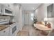 Bright eat-in kitchen featuring white cabinetry, and modern appliances plus easy access to the entry at 7301 W. Country Club N Dr # 108, Sarasota, FL 34243