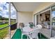 Covered lanai offering serene views of a pond and golf course, with comfortable seating for outdoor relaxation at 7301 W. Country Club N Dr # 108, Sarasota, FL 34243