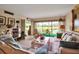 Bright living room featuring a large window with outdoor views, comfortable seating, and tasteful decor at 7301 W. Country Club N Dr # 108, Sarasota, FL 34243