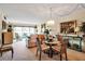 Inviting living room featuring a dining area, large windows with a view, and stylish decor at 7301 W. Country Club N Dr # 108, Sarasota, FL 34243