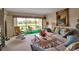 Inviting living room with waterfront views, comfortable seating, and stylish decor leading to outdoor seating at 7301 W. Country Club N Dr # 108, Sarasota, FL 34243