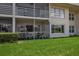 View of the outdoor patio with a green carpet, white furniture and beautiful landscape at 7301 W. Country Club N Dr # 108, Sarasota, FL 34243