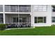 View of covered patio with green carpet and white outdoor furniture at 7301 W. Country Club N Dr # 108, Sarasota, FL 34243
