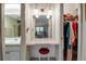 Vanity area with lighting, closet with hanging clothes, and view into attached bathroom for added convenience at 7301 W. Country Club N Dr # 108, Sarasota, FL 34243