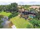 The aerial view highlights the backyard with a pool, outdoor seating, and beautiful waterfront views at 7605 Haddington Cv, Lakewood Ranch, FL 34202