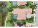 Aerial view of the residence showcases the private pool, red tile roof, and lush landscaping at 7605 Haddington Cv, Lakewood Ranch, FL 34202
