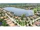 The aerial view shows a community surrounded by a large lake and lush landscaping at 7605 Haddington Cv, Lakewood Ranch, FL 34202