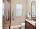 Bathroom featuring a glass shower, dark vanity, granite countertops, and tile flooring at 7605 Haddington Cv, Lakewood Ranch, FL 34202
