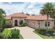 Well-maintained, charming one-story home featuring a tile roof, beautiful landscaping, and a brick driveway at 7605 Haddington Cv, Lakewood Ranch, FL 34202