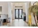 Elegant foyer with high ceilings, decorative lighting, tile floors, and stately columns at 7605 Haddington Cv, Lakewood Ranch, FL 34202