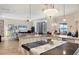 Expansive kitchen with granite countertops flows into a living area with large windows offering picturesque outdoor views at 7605 Haddington Cv, Lakewood Ranch, FL 34202