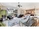 Bright and airy living room with a view of the pool, lanai, and lake, perfect for relaxing and entertaining at 7605 Haddington Cv, Lakewood Ranch, FL 34202
