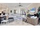 Open-concept living room boasts neutral tones, tile flooring, and plenty of natural light throughout at 7605 Haddington Cv, Lakewood Ranch, FL 34202
