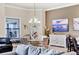 A bright and inviting living room features elegant decor, a dining area, and stylish furnishings at 7605 Haddington Cv, Lakewood Ranch, FL 34202