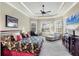 A spacious bedroom featuring tray ceilings, abundant natural light, and serene decor for relaxation at 7605 Haddington Cv, Lakewood Ranch, FL 34202