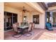 Covered patio area with dining table and chairs, ceiling fan and view of the outdoors at 7605 Haddington Cv, Lakewood Ranch, FL 34202