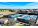 Active pickleball courts in a sunny community setting, featuring well-maintained facilities surrounded by residential homes at 7605 Haddington Cv, Lakewood Ranch, FL 34202