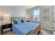 Relaxing bedroom with paneled accent wall, large window, and soft, neutral decor at 8009 20Th W Pl, Bradenton, FL 34209