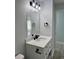 Bathroom with white vanity, a large mirror, and modern black fixtures at 811 24Th Street E Ct, Bradenton, FL 34208