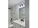 Updated bathroom featuring a vanity with a marble countertop, modern fixtures, and tiled walls at 811 24Th Street E Ct, Bradenton, FL 34208