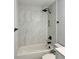 Updated bathroom featuring modern black fixtures and a fully tiled tub surround at 811 24Th Street E Ct, Bradenton, FL 34208