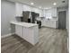 Renovated kitchen featuring white cabinets, stainless steel appliances, and stylish flooring at 811 24Th Street E Ct, Bradenton, FL 34208
