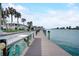 Long wooden dock with view of condos and a utility sink for fisherman at 999 Inlet Cir # 103, Venice, FL 34285