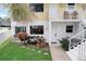 Ground level condo unit with bright landscaping and a cozy outdoor seating area near the entrance at 999 Inlet Cir # 103, Venice, FL 34285