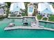 Stunning aerial shot of waterfront homes with docks and a shared pool, perfect for relaxation at 999 Inlet Cir # 103, Venice, FL 34285