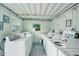 Clean and organized laundry room featuring multiple washing machines and ample space at 999 Inlet Cir # 103, Venice, FL 34285