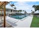 Community pool surrounded by lush landscaping and comfortable lounge chairs at 999 Inlet Cir # 103, Venice, FL 34285