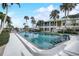 Inviting pool and sunning area with clear water and tropical landscaping at 999 Inlet Cir # 103, Venice, FL 34285