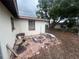 Backyard featuring a fire pit, brick pavers, and trees, providing a serene outdoor space at 11234 Areca Dr, Port Richey, FL 34668