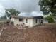 Backyard showcasing a fire pit and trees, offering a serene outdoor space at 11234 Areca Dr, Port Richey, FL 34668