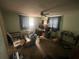 Room with a ceiling fan, window and desk, providing a simple workspace at 11234 Areca Dr, Port Richey, FL 34668